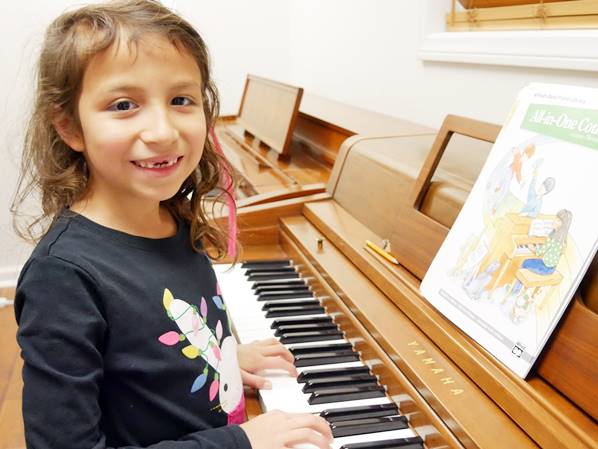 Piano with small girl in MUSIC LESSON