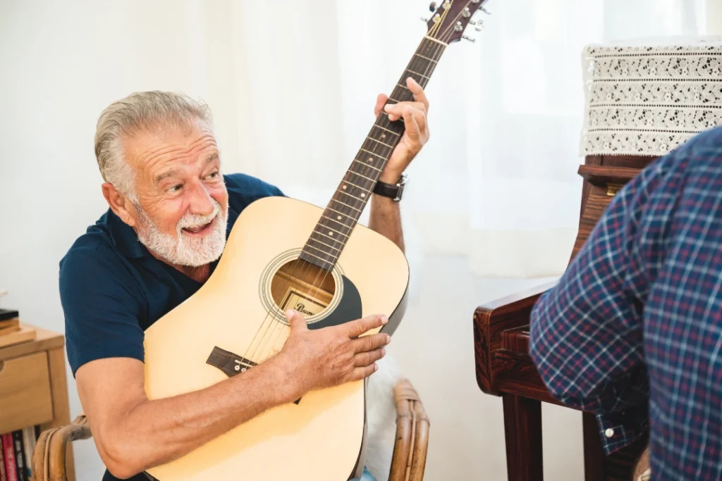 A student of any age practicing a musical instrument with guidance from an instructor in a warm, welcoming music studio