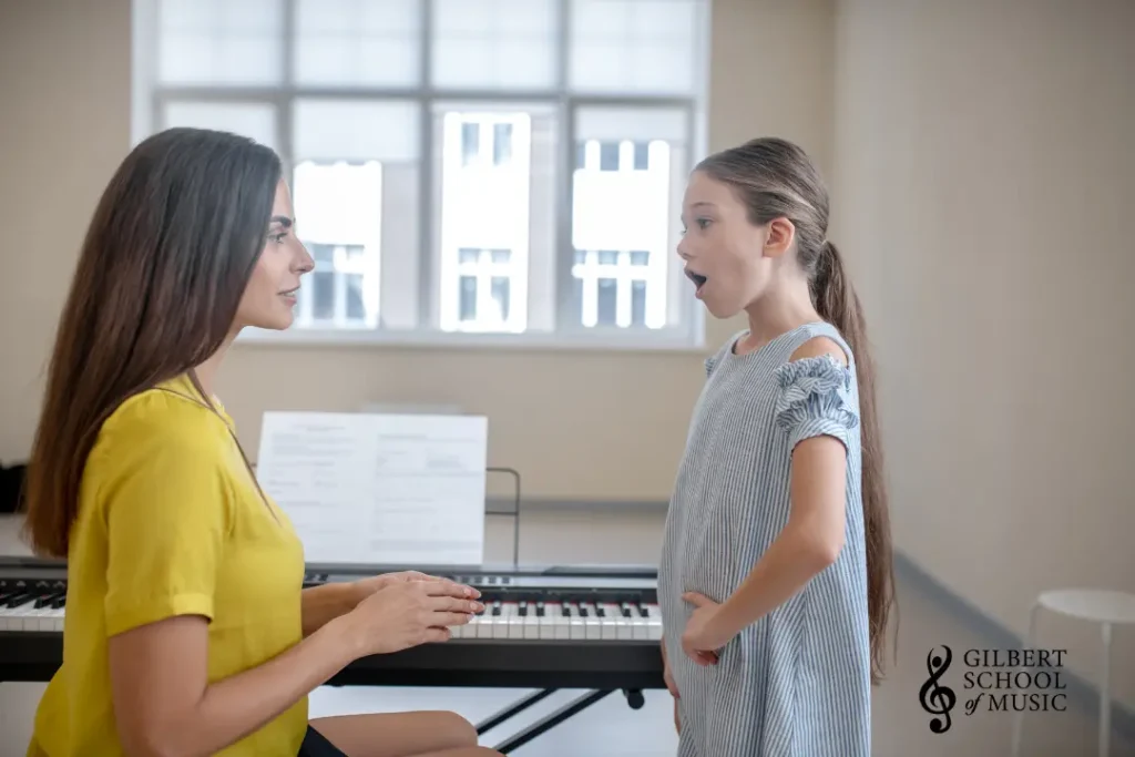 Child practicing singing at home with online vocal exercises while preparing for in-person voice lessons at Gilbert School of Music