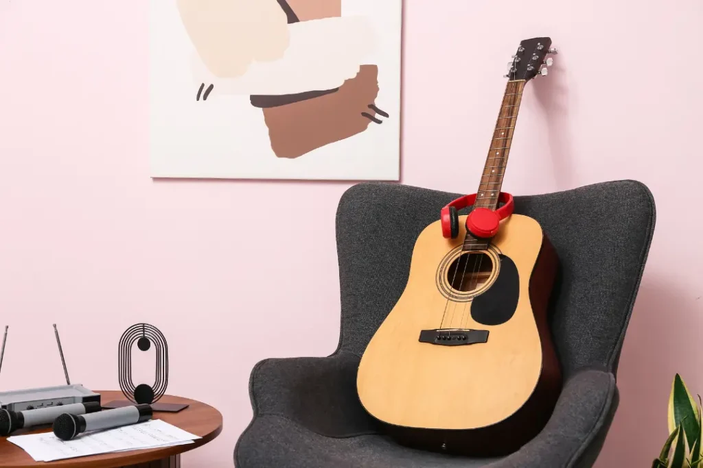 Acoustic guitar resting on a chair in a music classroom ready for beginner guitar lessons