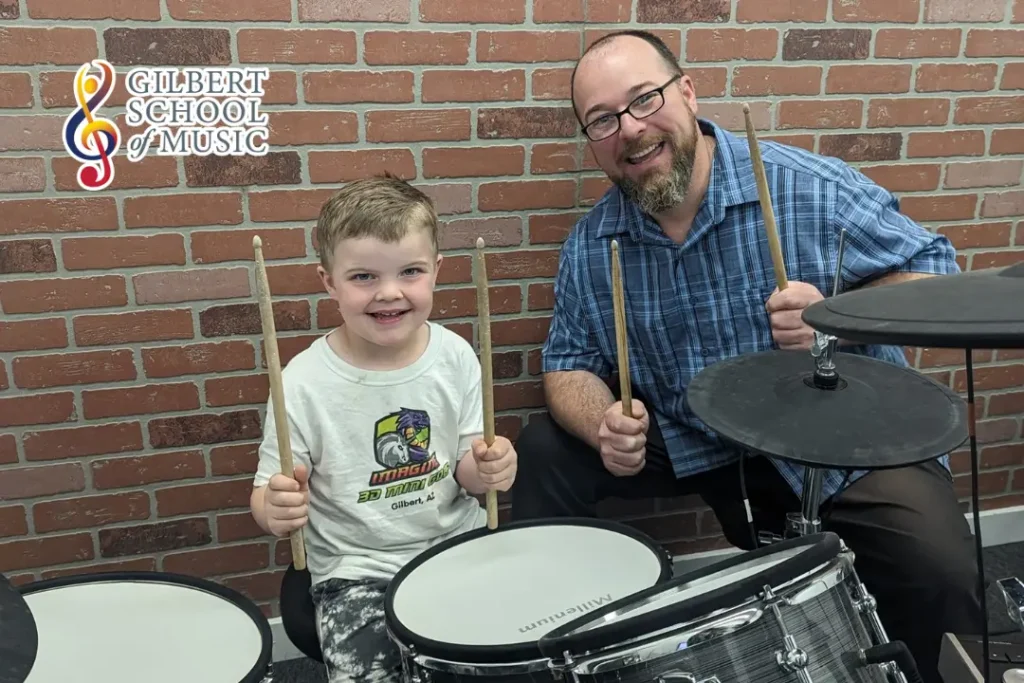 Child learning drum techniques during a private drum class at Gilbert School of Music