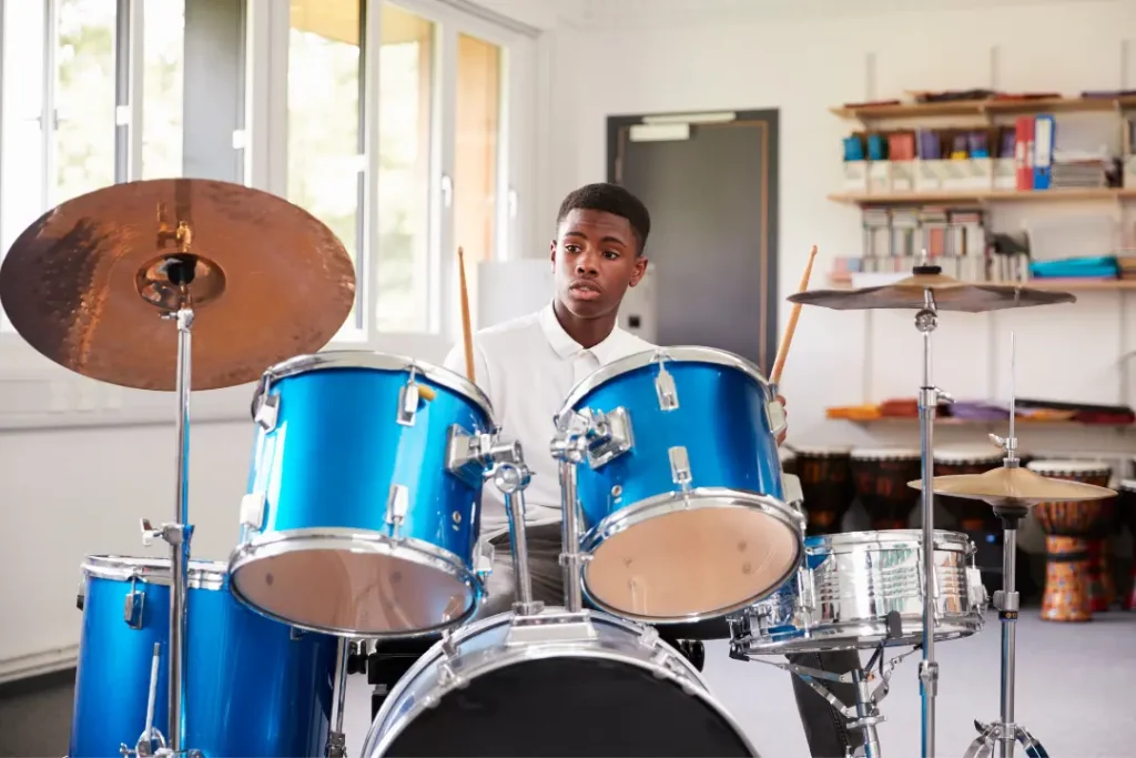 Drum set with various percussion instruments on the side, highlighting beginner drum lessons